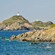 A lighthouse perched on a hilltop overlooking the rocky coastline and ocean